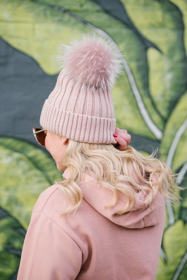 Bows & Sequins wearing a blush pink pom pom beanie.