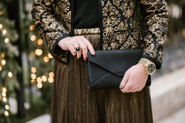 Bows & Sequins wearing a festive black and gold outfit.