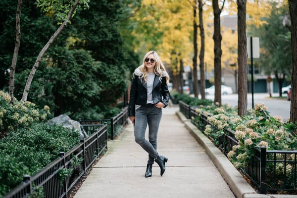 Bows & Sequins styling a moto jacket and grey skinny jeans for fall in Chicago.