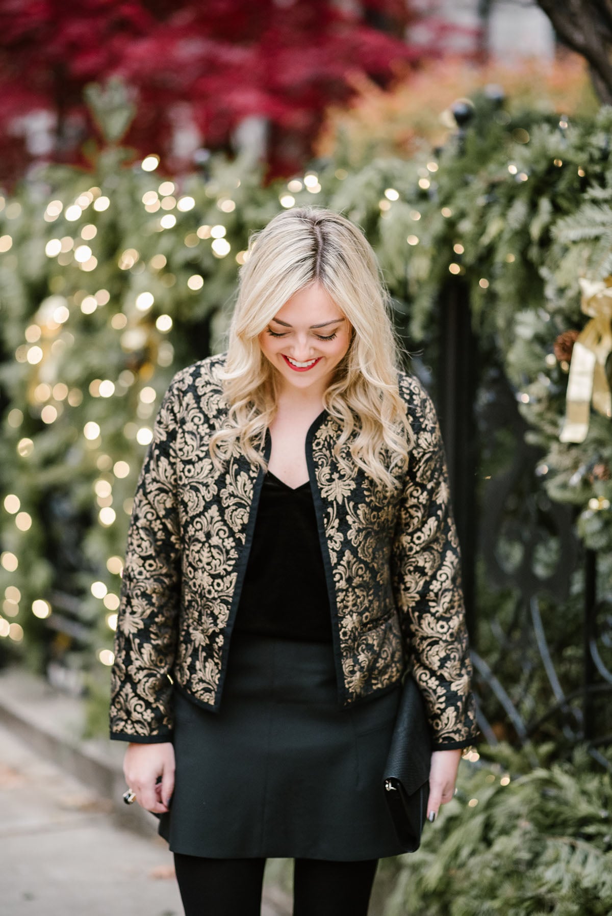 Jessica Sturdy, Chicago-based fashion, travel, and lifestyle blogger, styling a black and gold embroidered jacket for the holidays.