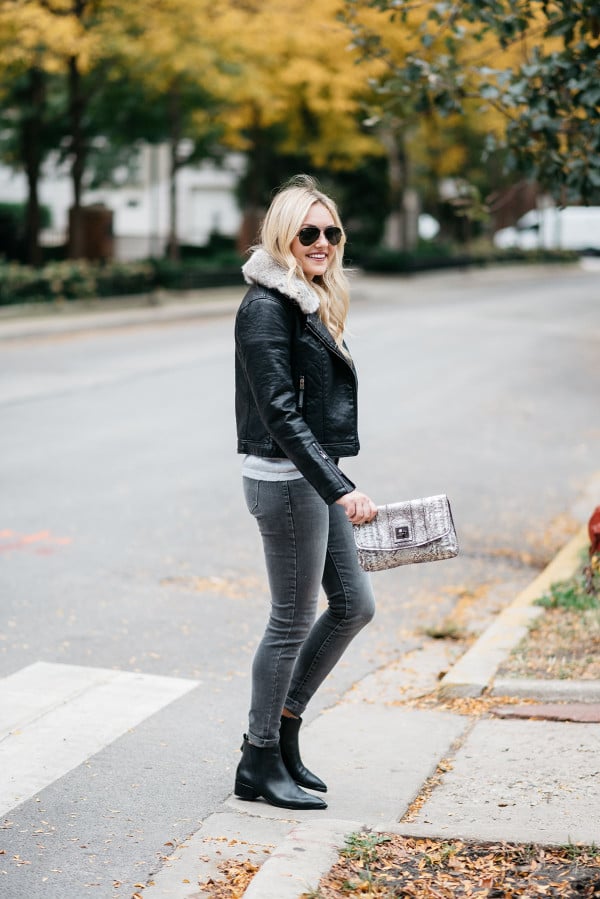Bows & Sequins wearing a faux leather moto jacket with grey skinny jeans in Chicago.