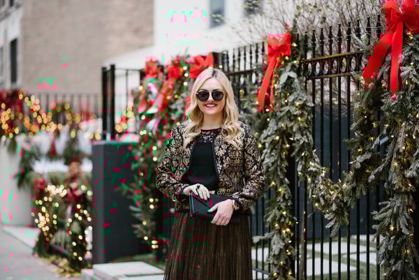 Bows & Sequins wearing a black and gold jacquard jacket, black lace yoke top, and a gold skirt for a Chirstmas party during the holiday season.