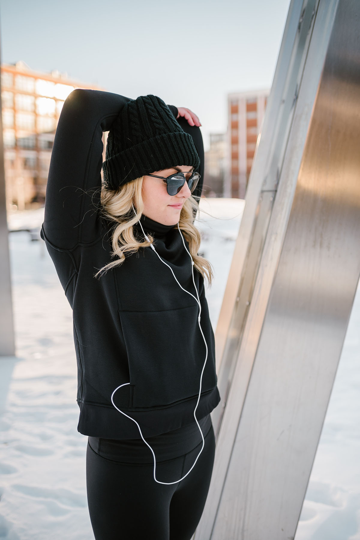 Bows & Sequins wearing a lululemon turtleneck, black sunglasses, and a beanie.