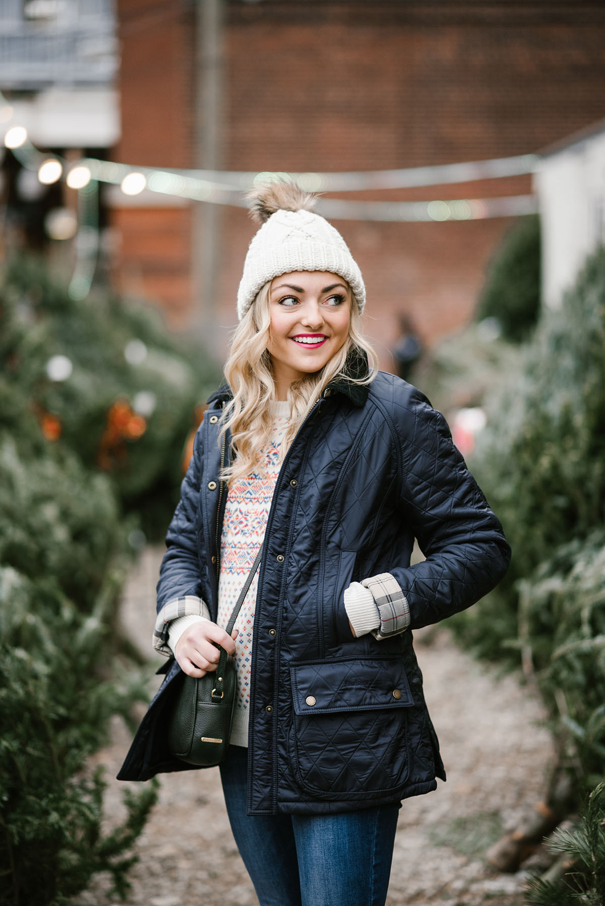 Bows & Sequins wearing a Barbour jacket, J.Crew Fair Isle Sweater, and a Tuckernuck pom pom beanie to pick out a Christmas tree in Chicago.