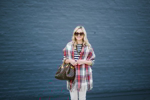Bows & Sequins wearing a tartan plaid blanket scarf with a striped shirt and white jeans.