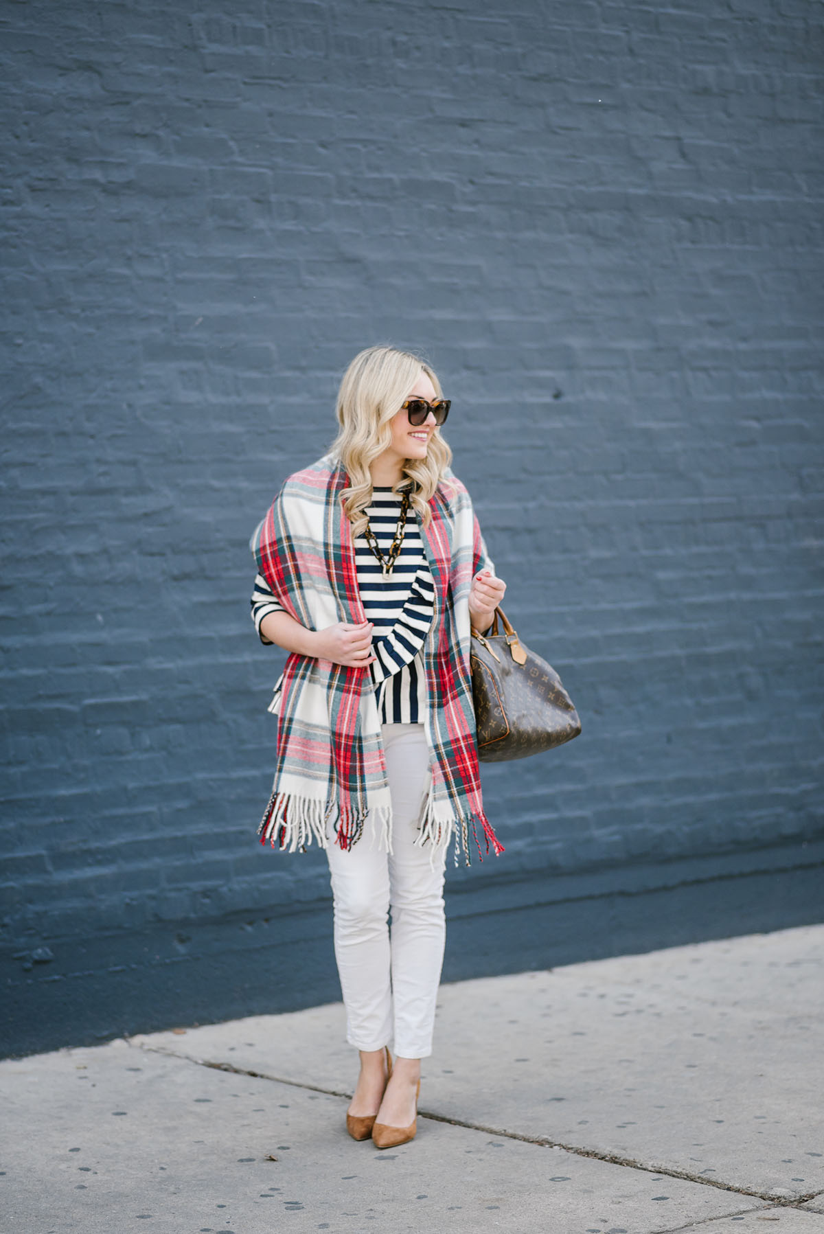 Bows & Sequins styling a plaid scarf over a striped top and white jeans.