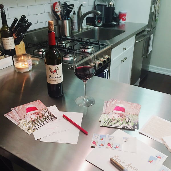 Bows & Sequins writing in holiday cards in her NYC Lower East Side apartment.