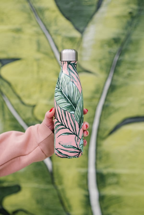 Bows & Sequins with the pink and palm leaf S'well Palm Leaf water bottle.