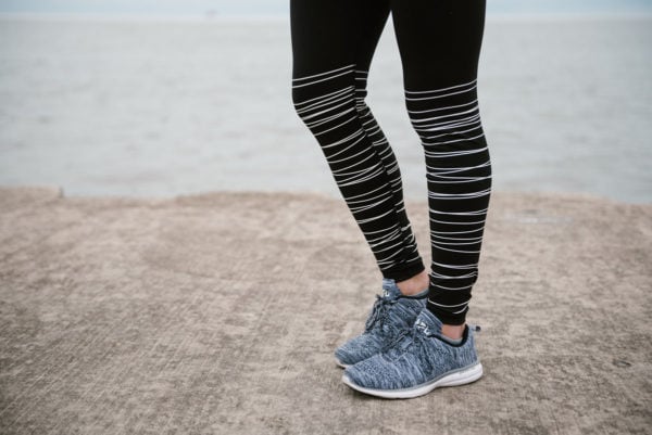 Bows & Sequins wearing Old Navy workout leggings and APL sneakers.