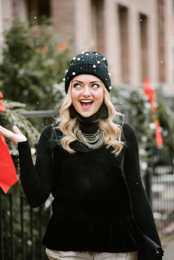 Bows & Sequins wearing a black beanie with pearls.