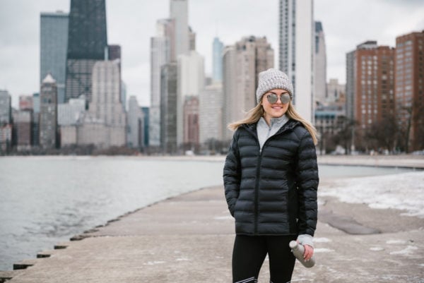 Bows & Sequins wearing a grey Love Your Melon beanie with a black puffer coat and mirrored sunglasses.