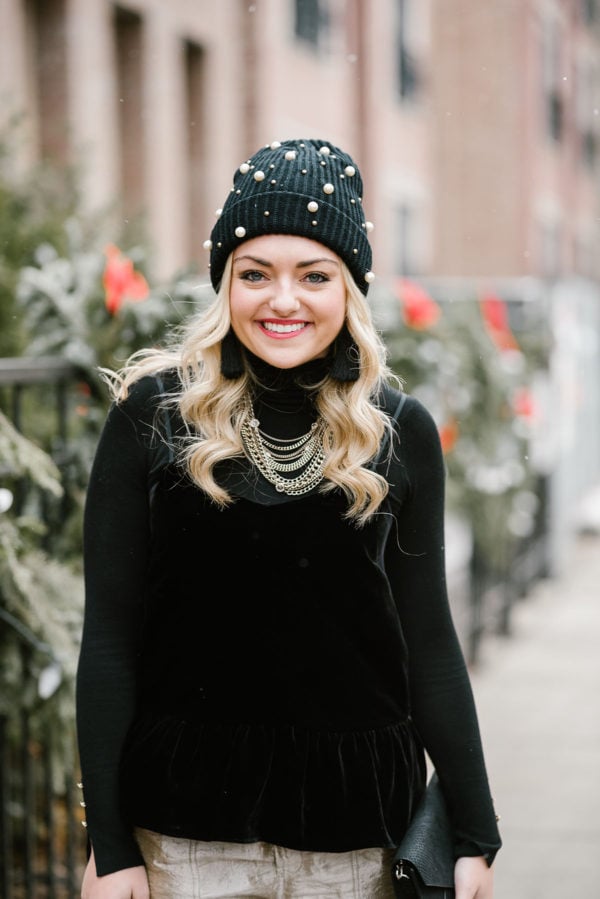 Bows & Sequins wearing a black velvet cami with a black turtleneck layered underneath.