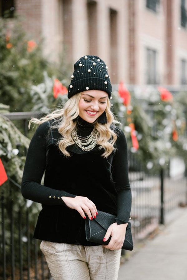 Bows & Sequins wearing a black velvet cami with a black turtleneck layered underneath.