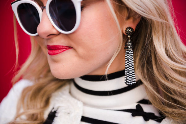 Bows & Sequins wearing black and white tassel earrings from BaubleBar.