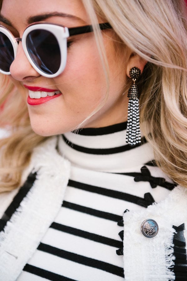 Bows & Sequins wearing black and white tassel earrings from BaubleBar.