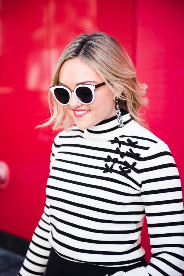 Bows & Sequins wearing a black and white striped turtleneck with bows.