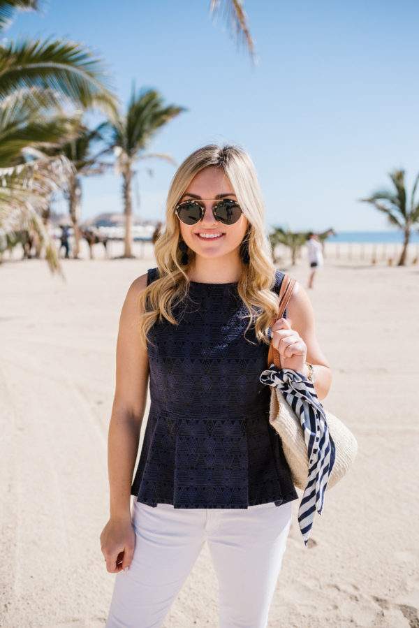 Bows & Sequins styling a Sail to Sable peplum top with a Kate Spade silk scarf and a straw tote.