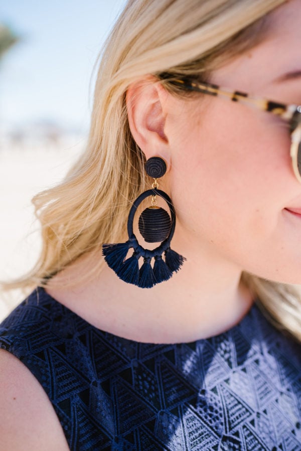 Bows & Sequins styling Tuckernuck dreamcatcher earrings on the beach in Cabo.