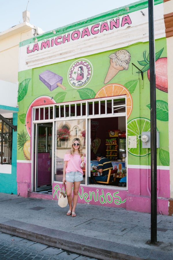 Bows & Sequins wearing a pink Vineyard Vines top and Amuse Society jean shorts at La Michoacana ice cream shop in downtown San Jose del Cabo Mexico.
