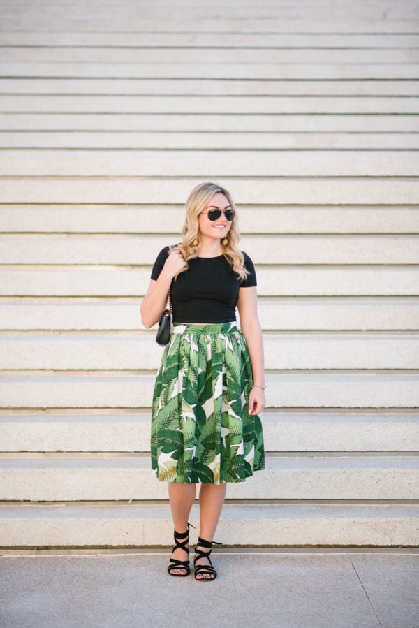 Bows & Sequins wearing a black Nordstrom BP tee shirt with a palm leaf skirt and Ray-Ban aviators.
