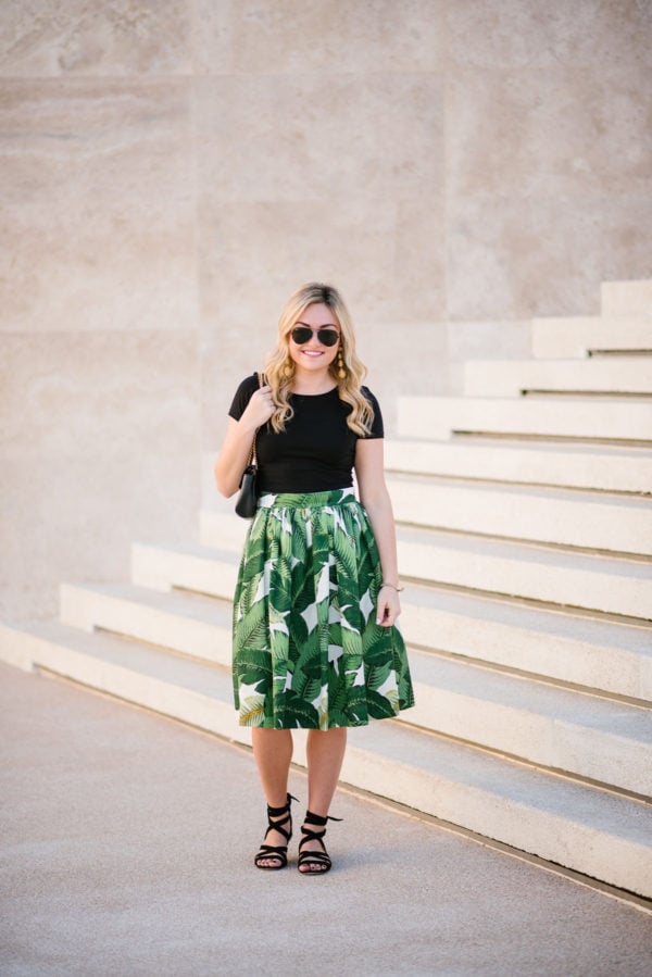 Lifestyle blogger wearing a black crop top tee with a Gucci Marmont bag and Ray-Ban black aviators at the Paradisus hotel.