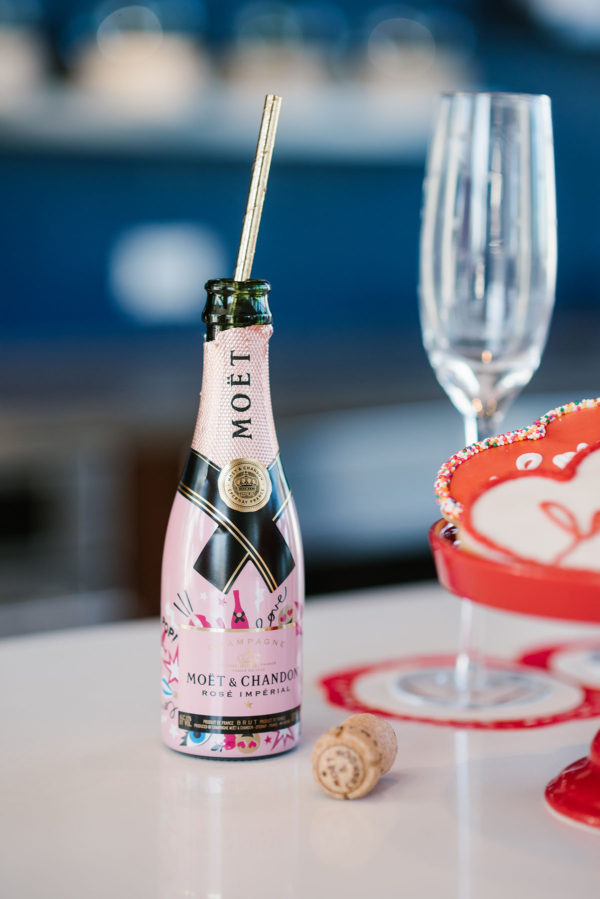 Bows & Sequins hosting a Valentine's Day party with mini bottles of champagne.