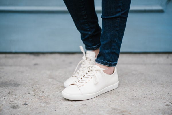 Bows & Sequins wearing Sezane Jack sneakers in cream-colored leather.