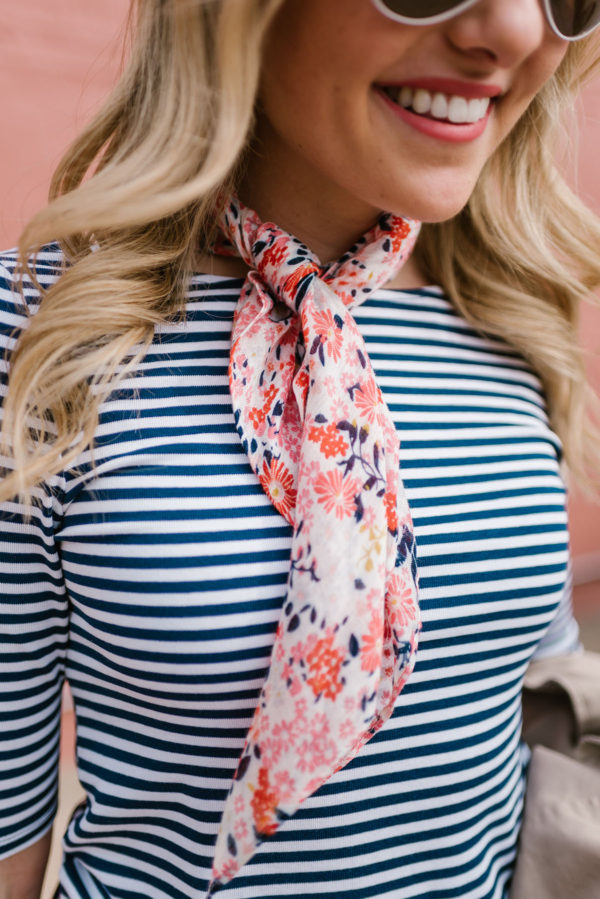 Fashion writer Bows & Sequins wearing a navy striped scoop tee with a floral printed neckerchief scarf.