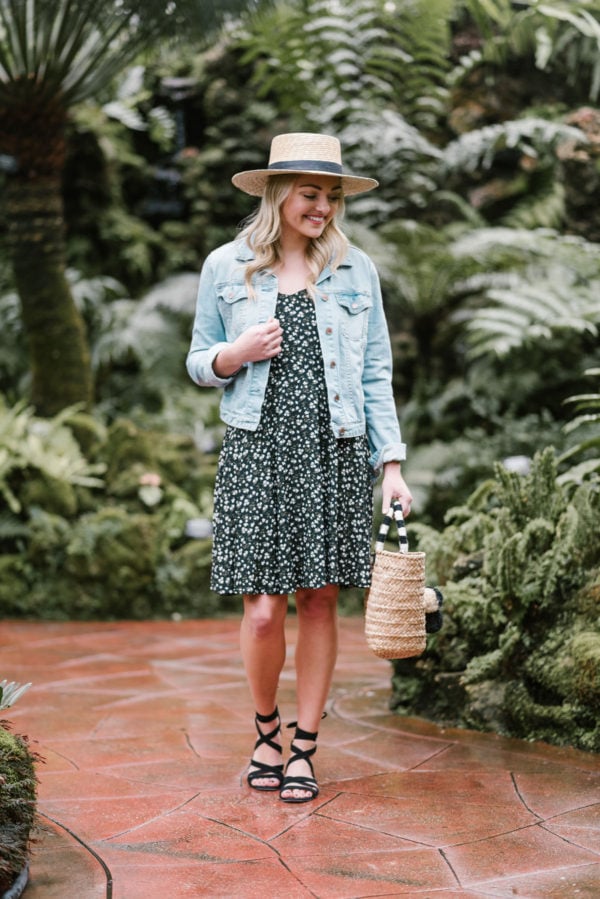 Bows & Sequins wearing a denim jacket and an Old Navy dress in an arboretum.