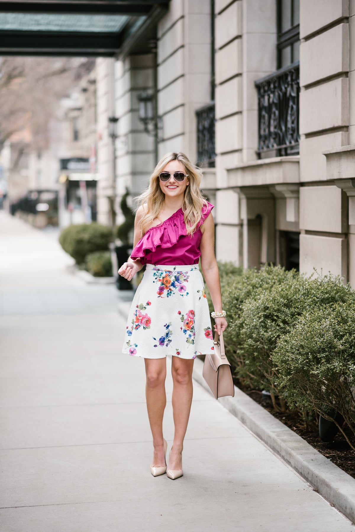 Chicago style blogger Bows & Sequins wearing a fuchsia Devlin top and a floral skirt with a Cuyana satchel.