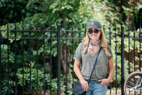 Fashion blogger Bows & Sequins wearing a v-neck tee with a patterned bandana and a Gucci crossbody bag.
