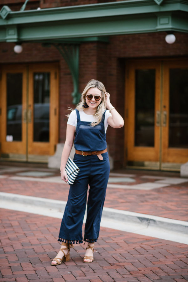 Bows & Sequins styling a navy blue jumpsuit with tassels on the hem in Lincoln Park by North Pond.