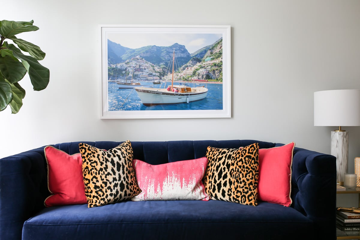 Bows & Sequins Chicago living room decor with Gray Malin print, custom Society Social navy blue velvet couch, and pink and leopard print pillows.