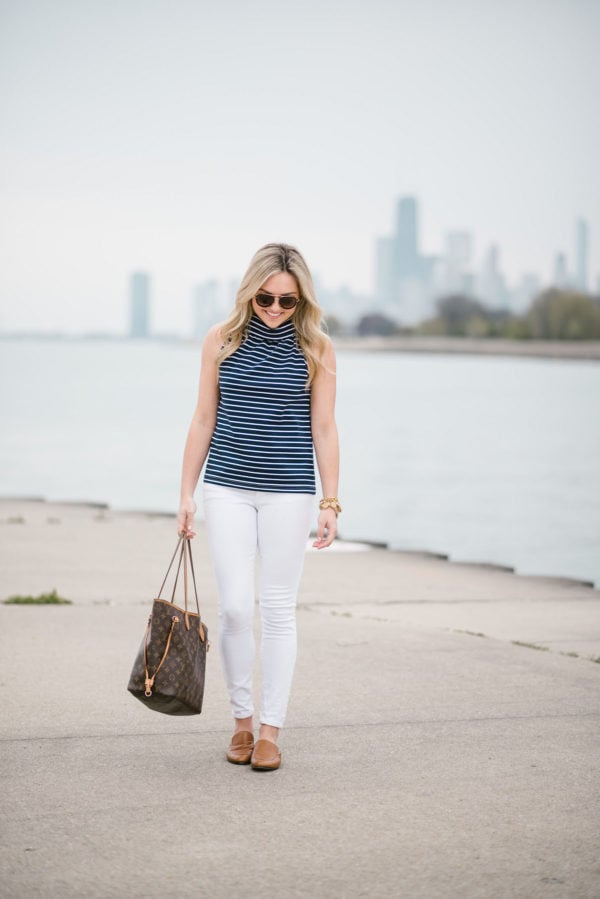 Jessica of Bows & Sequins, a fashion-focused lifestyle blog, wearing a Sail to Sable striped top with Old Navy white denim, a Louis Vuitton Neverfull bag, and Dune London leather loafers.