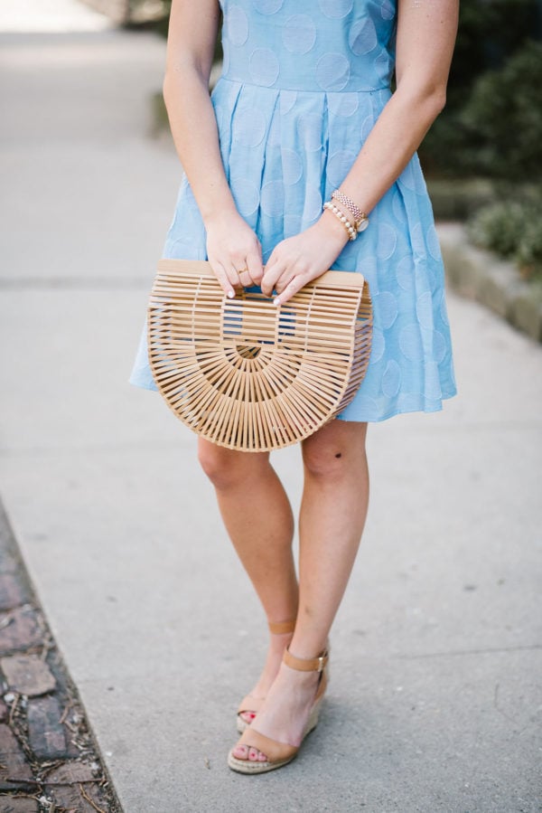 Lifestyle blogger Bows & Sequins styling a hydrangea blue dress with a Cult Gaia Bamboo Arc bag and Vince Camuto leather ankle strap wedge sandals.