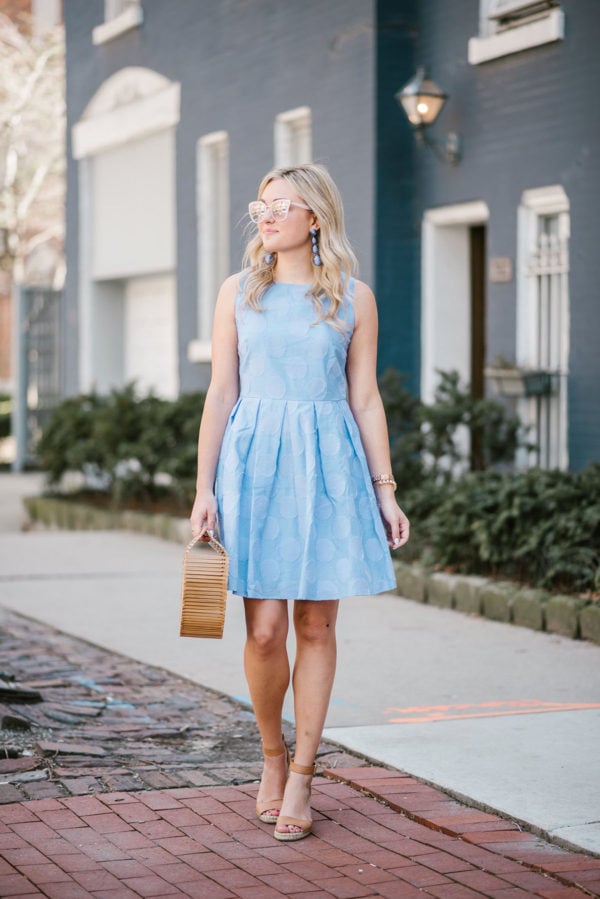 Fashion blogger Bows & Sequins wearing a fit & flare Sail to Sable dress with a Lele Sadoughi pearl cuff, Kenneth Jay Lane statement earrings, and a Cult Gaia bag.