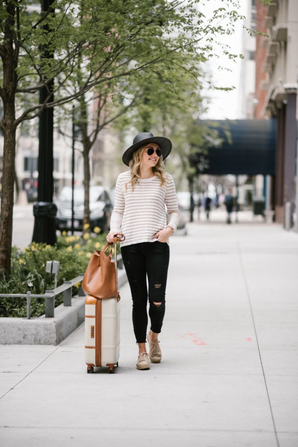 Fashion blogger Bows & Sequins wearing a Kenzie sweater with Old Navy black jeans, a straw hat, and espadrille sneakers.