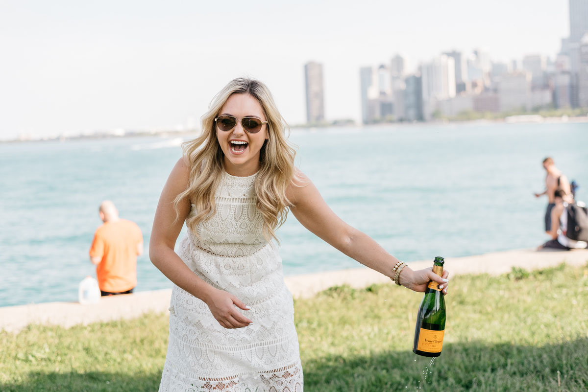 Fashion blogger Bows & Sequins popping open a bottle of Veuve Clicquot champagne.