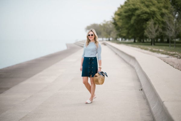 Bows & Sequins styling a navy striped tee with a Kensie lace-up skirt and Kurt Geiger slides in Chicago.