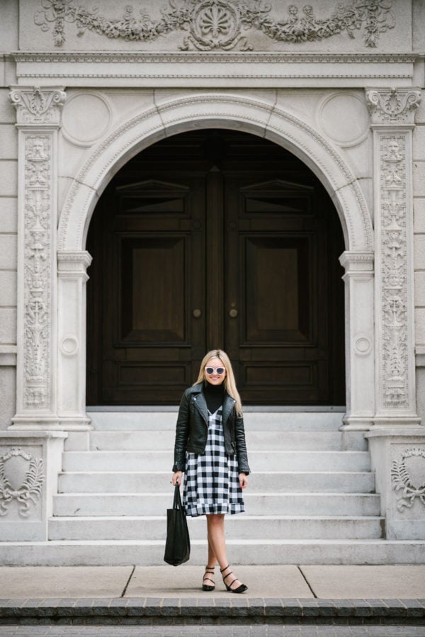 Chicago blogger Bows & Sequins wearing a Topshop moto jacket, Modcloth gingham dress, and Zara patent strappy Mary Janes with a leather tote and Nordstrom sunglasses.