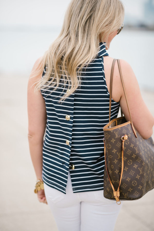 Chicago-based lifestyle blogger Jessica Sturdy wearing a Sail to Sable striped halter top with white jeans and a Louis Vuitton tote.