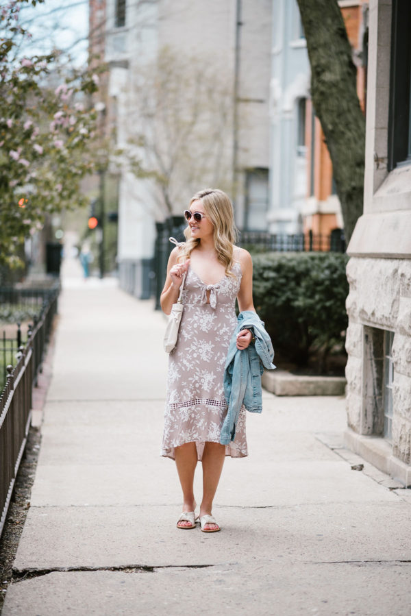 Fashion blogger Bows & Sequins wearing an ASTR tie-front floral midi dress with Call It Spring sunglasses, Soludos knotted slides, and a Clare V Petit Henri bag.