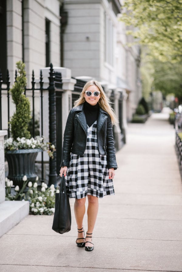 Chicago lifestyle blogger Jessica Sturdy styling a Modcloth black gingham midi dress with a Topshop moto jacket and J.Crew tissue turtleneck with a leather tote, Nordstrom sunglasses, and Zara Mary Janes.