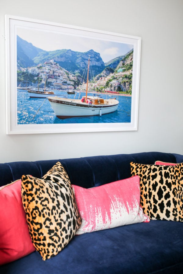 Bows & Sequins custom navy velvet Society Social couch with pink and leopard throw pillows and framed Gray Malin Italy print.