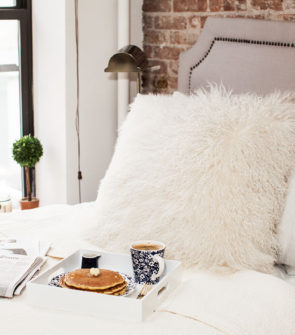Lifestyle blogger Bows & Sequins with a breakfast in bed setup in her Lower East Side apartment in NYC