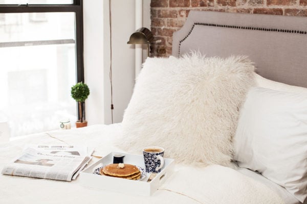Lifestyle blogger Bows & Sequins with a breakfast in bed setup in her Lower East Side apartment in NYC