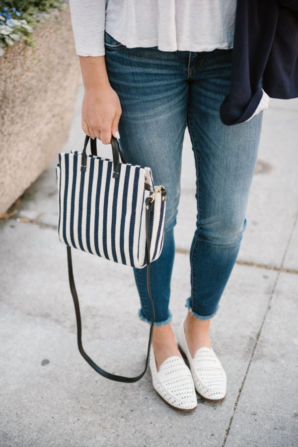 Bows & Sequins wearing Kut from the Cloth raw hem skinny jeans and Sam Edelman woven leather loafers, holding a Clare V striped crossbody bag.