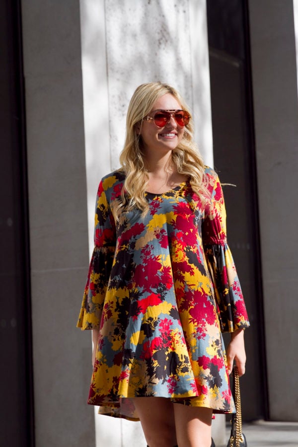 Bows & Sequins wearing a printed floral bell sleeve fall dress in London.