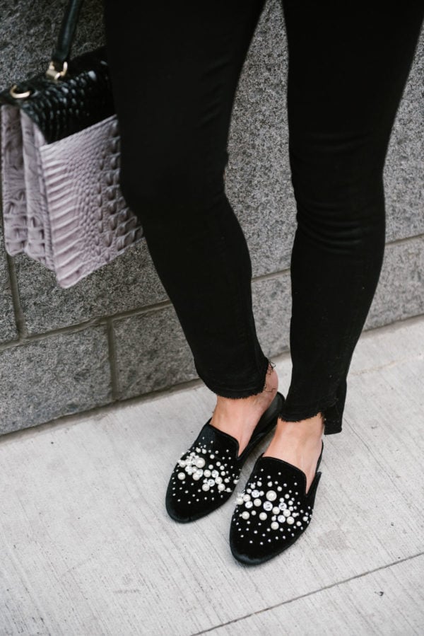 Bows & Sequins wearing raw hem black denim and black Steve Madden pearl slides.