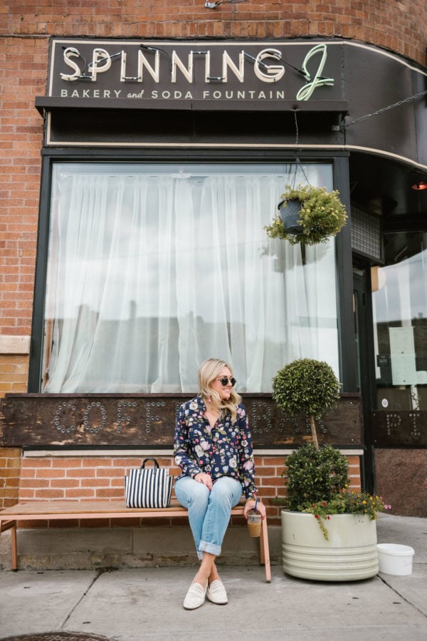 Bows & Sequins wearing cuffed straight leg jeans with a Rebecca Taylor floral blouse and Sam Edelman white loafers at the Spinning J coffee shop in Chicago.